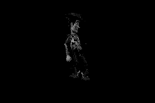 a black and white photo of a toy story woody doll walking in the dark .