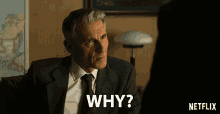 a man in a suit and tie asks the question " why "