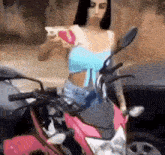 a woman is sitting on a pink motorcycle taking a picture of herself .