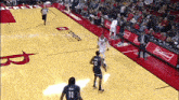 a basketball game is being played on a court sponsored by toyota