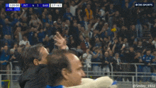 two men giving each other a high five during a soccer game