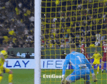 a soccer game is being played in front of a banner that says ife