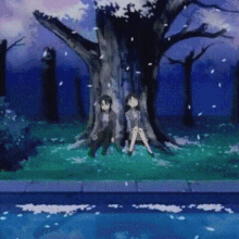 a man and a woman are sitting under a tree with cherry blossoms falling