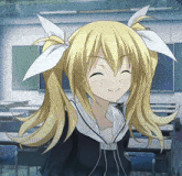 a girl with blonde hair and white bows on her ears smiles in a classroom