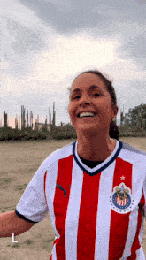 a woman wearing a red and white striped shirt with a star on the front
