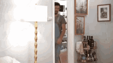 a man in overalls is standing in a doorway