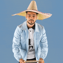 a man wearing a sombrero is holding a chalkboard that says gg on it