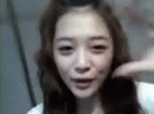 a woman 's face is shown in a blurry photo with her eyes closed