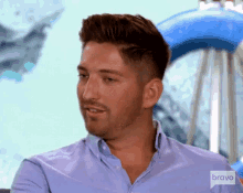 a man wearing a blue shirt with the word bravo on the bottom