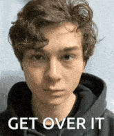 a young man wearing a black hoodie with the words get over it written on the bottom