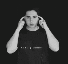 a man wearing a black shirt that says paris