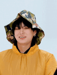 a man wearing a hat and a yellow jacket