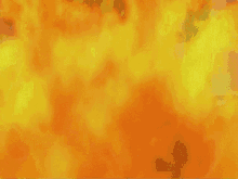 rogue from the x-men is standing in front of a fireball .
