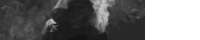 a black and white photo of a person standing in a dark room with smoke coming out of their mouth .