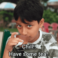 a young boy drinking from a cup with the words chill have some tea below him