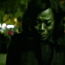 a blurry picture of a woman 's face in a dark room