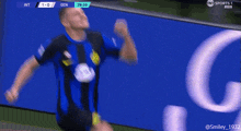 a soccer player celebrates a goal in front of a sports 1 banner
