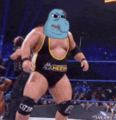a wrestler with a cartoon face on his chest is wearing a heavy wrestling outfit