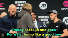 paddy sees ilia and goes for a fist bump like a good boy on a sign