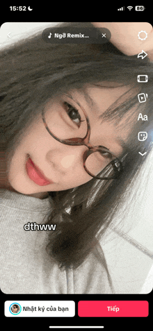 a phone screen shows a girl wearing glasses and the words dthww on the bottom