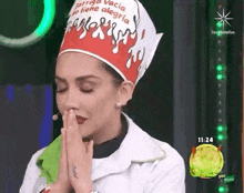 a woman wearing a chef hat is praying with her hands folded