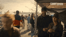 a man and a woman are standing in front of a tent with the word countdown on it