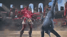 a man and a woman are fighting in a ring and the woman is covered in blood
