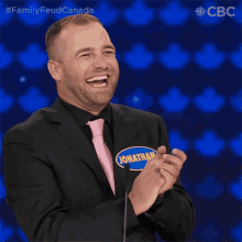 a man in a suit and tie with a name tag that says jon