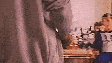 a man is standing in front of a table in a room .