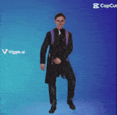 a man in a suit and tie is dancing in front of a blue background that says capcut on it
