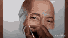 a drawing of a man 's face is being made by animatica