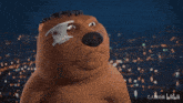 a teddy bear with a bandage on its eye is looking at the camera