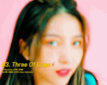 a close up of a woman 's face with the words three of cups written on the bottom