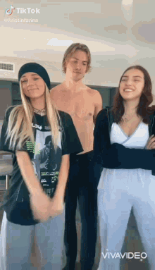 a group of people are standing next to each other in a living room .