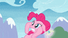 a pink pony with a blue sky and mountains behind it
