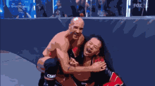 two men wrestling in front of a smackdown banner