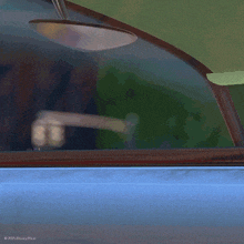 a close up of a person 's hands in a car with a disney pixar logo on the bottom