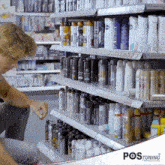 a woman in a store looking at a shelf full of deodorants