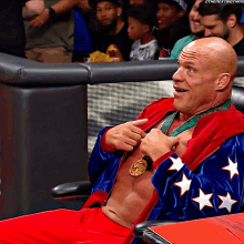 a man wearing a medal around his neck is sitting in a chair with a caption that says ' the next thing '