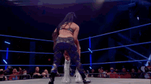 a wrestling match is underway with the word glory in the background