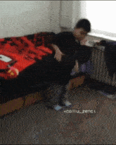 a person is laying on a bed with a red blanket
