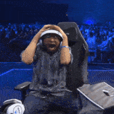 a man is sitting in a chair that says blackly on the back