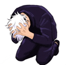 a man is kneeling down with his head in his hands and covering his face .