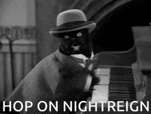 a black cat in a hat is playing a piano with the words hop on nightreign written below it
