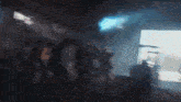 a blurry picture of a group of people dancing in a dark room