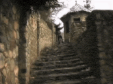 a person walking down a set of stone stairs
