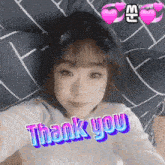 a girl laying on a bed with the words thank you written on her face