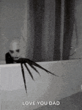 a scary clown is sitting in a bathtub with a shower curtain behind him .