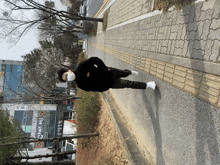 a person wearing a mask is walking down a sidewalk in front of a building that says net banking