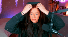 a woman wearing a shure microphone adjusts her hood
